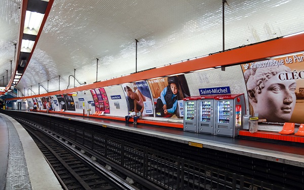 row of subway ads along an empty subway station