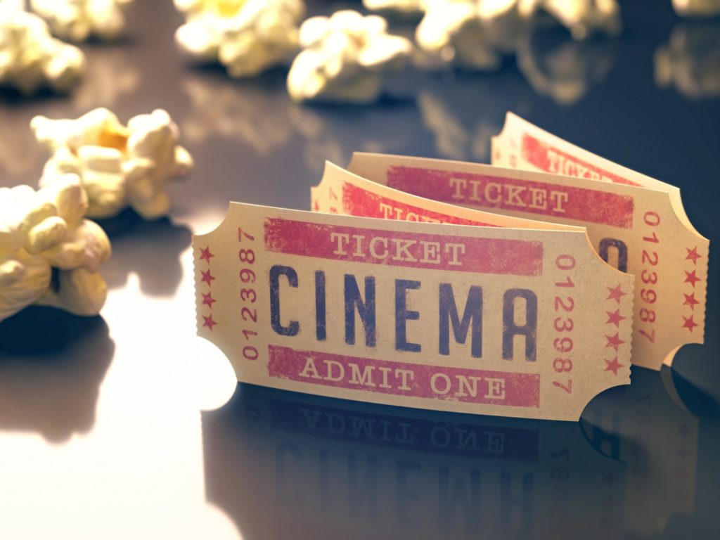 Oldfashioned entry ticket to the cinema with popcorn around