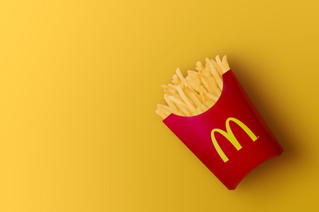 McDonald's French fries in the French fries box on red background