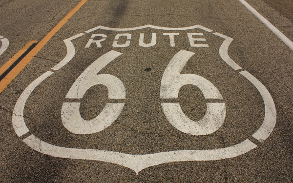 Route,66,Original,Section,Logo,At,Amboy,,California,,Close,Up white template placeholder of an advertising billboard on the rooftop of a modern building framed by trees